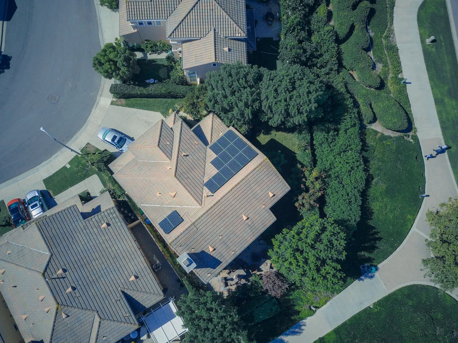 A residential rooftop fitted with solar panels, glowing in the late-day sun